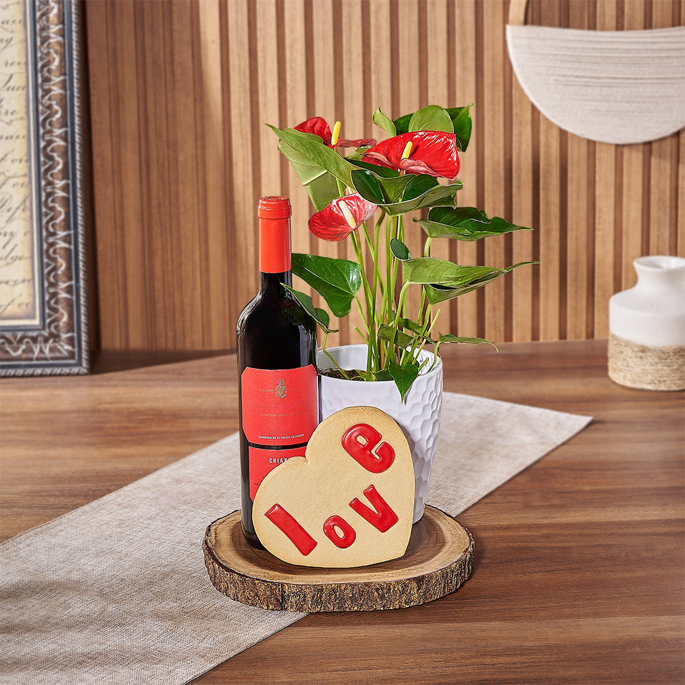 This Valentine's Day, show someone special they're on your mind with a bottle of wine, a potted Anthurium plant, a heart-shaped cookie that says ‘love’, and a live-edge serving board, America delivery